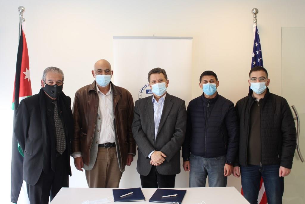 Participants pose for a group photo during the signing of a  joint action plan between the USAID Recycling in Jordan activity and the Organic Fertilisers Eco Systems Association on Wednesday (Photo courtesy of USAID)